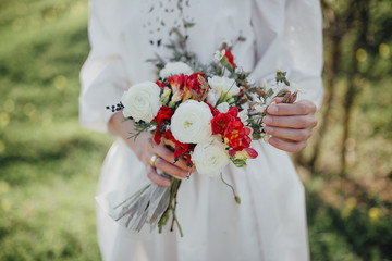 wedding bouquet of red and white flowers and greenery
