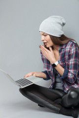 Beautiful woman is entertaining herself with laptop