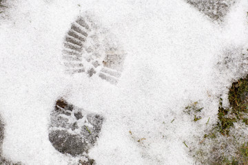 Boot print in the snow. Footprint of a shoe, winter landscape. 