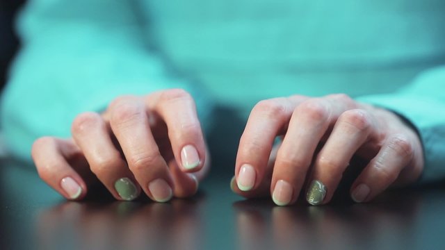 Women's Hands Nervously Tapping Fingers On The Table