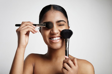 woman have fun with a cosmetic brushes