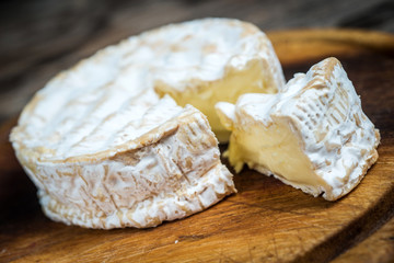Closeup slice camembert cheese - obrazy, fototapety, plakaty