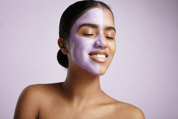 happy woman with closed eyes and a half a face with a mask