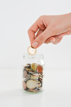 Money or coins in a full jar suggesting home savings