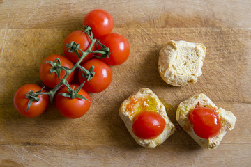 Bread with tomatoes on chopping board. Frise, friselle