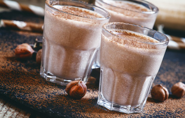 Banana chocolate smoothie with nuts, dusted with a powder, healt