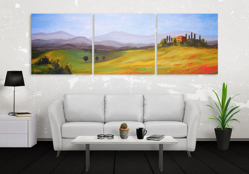 Landscape on wall art canvas in three parts. Sofa, lamp, plant and table in room interior.
