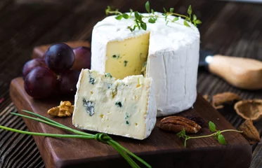 Fototapeten Blue cheese on wooden background © Daniel Vincek