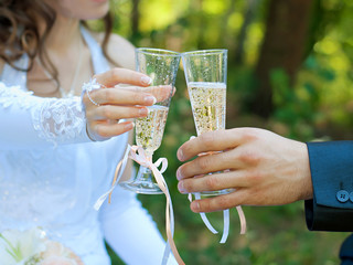 Bride and groom holding glasses with champagne. Soft focus