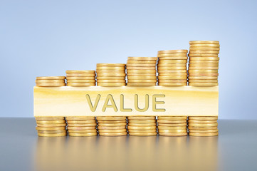 Stack of golden coin with word written on wood