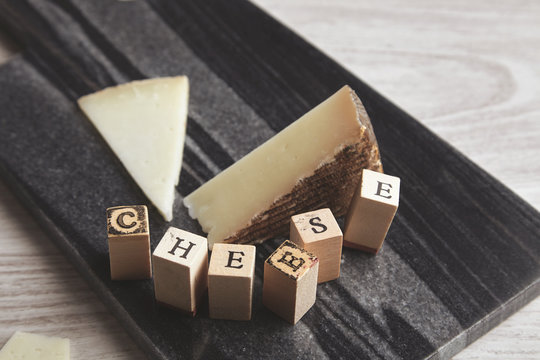close focus wooden letters side goat cheese isolated