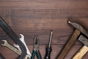 rusty construction tools on the wooden background