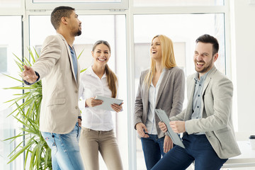 Group of smiling business people standing and communicating