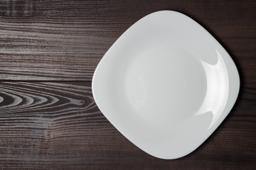 square plate on the wooden brown table