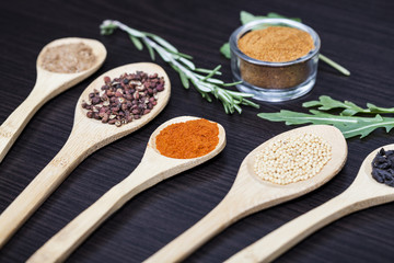 Colorful spices and wooden cutlery