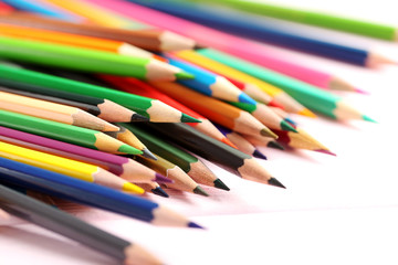 Drawing colourful pencils on a wooden background