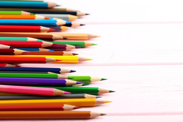 Drawing colourful pencils on a wooden background