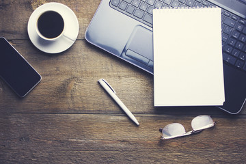 glasses on computer, coffee and paper