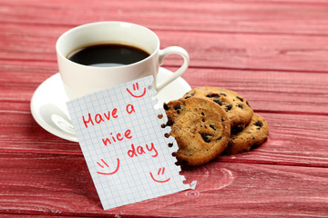 Piece of note paper on red wooden background