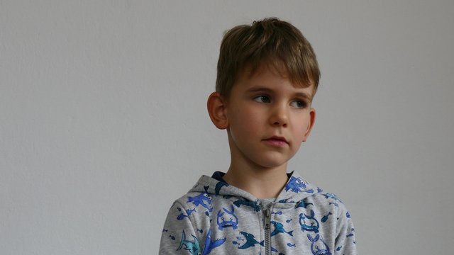 Boy of five years makes expressions and talk.