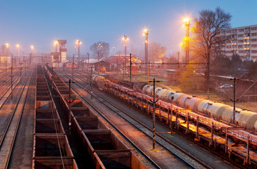 Fototapeta na wymiar Cargo freigt train railroad station at dusk