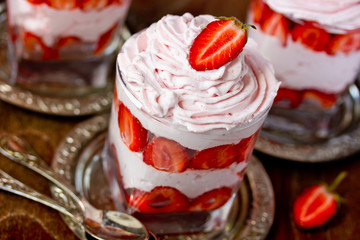 Dessert strawberry with whipped cream in a glass close-up
