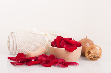 Rose petals, mortar, towel ,sponge and candle, spa theme