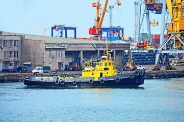 Fototapeta premium Tugboat and port cargo crane