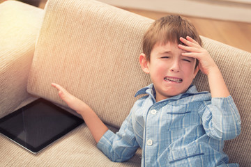 Little boy crying about digital tablet