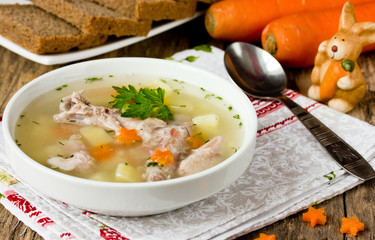 Easter soup with rabbit and carrots stars selective focus