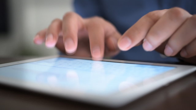 Hand touching screen on modern digital tablet pc.