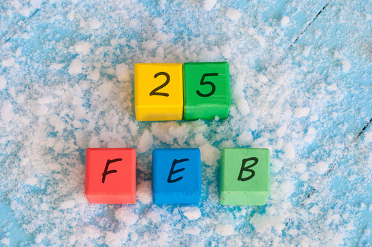 February 25th. Calendar date on color wooden cubes with marked Date 25 of february. Winter end concept - Powered by Adobe