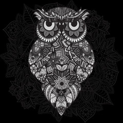 Patterned vector owl on the ornamental mandala background. African, indian, totem, tattoo design. Vector owl in tribal. doodle isolated black and white owl