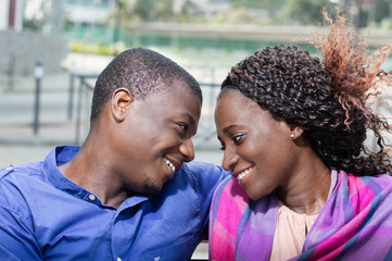 Young couple sitting on a bench.