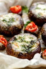 Baked portobello mushrooms stuffed with cheese and vegetables