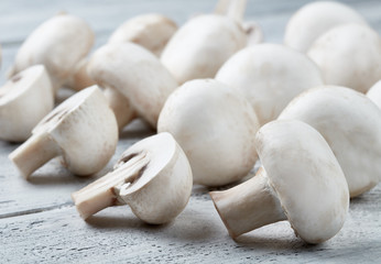 Champignon on white wooden background