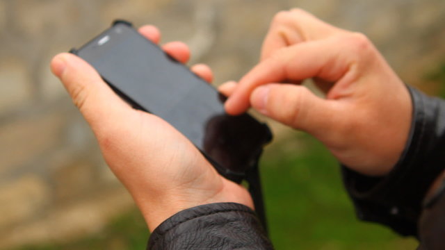man typing a message on a smartphone
