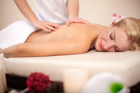 Woman getting recreation massage in spa salon