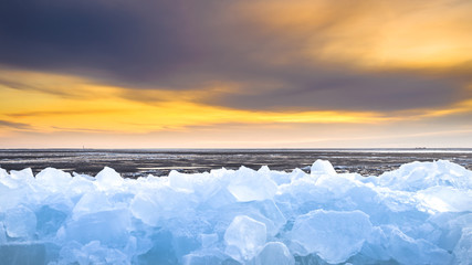 Pieces of drifting ice at sunset, IJsselmeer, Netherlands © fotografiecor