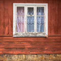 closed old window on a aged wooden wall