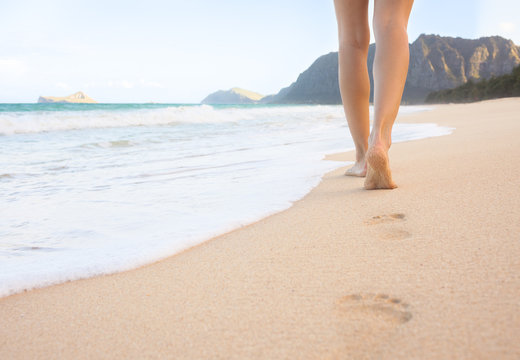 Woman walking on the beach in beautiful Hawaii. 