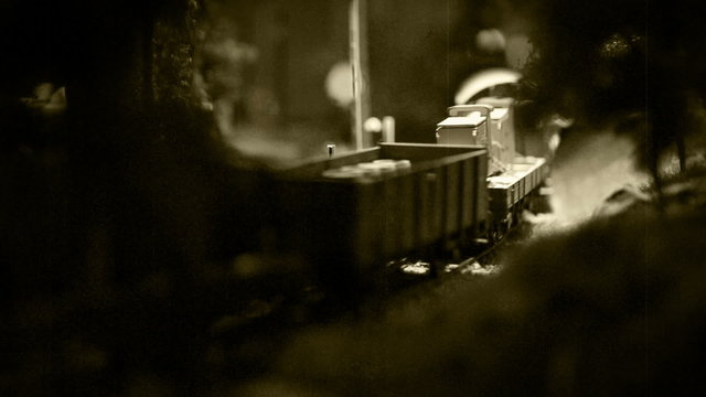 Old film effect footage model railway with old-fashioned locomotive on the route