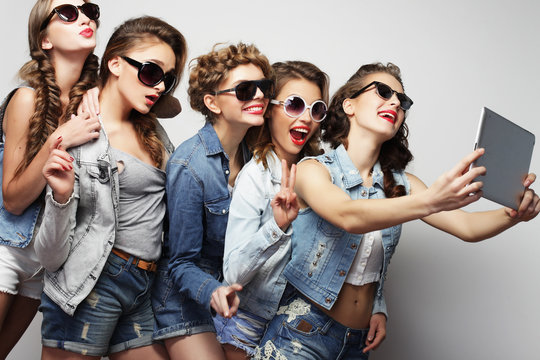  five hipster girls friends taking selfie with digital tablet