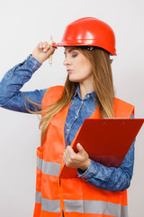 Woman engineer construction builder in helmet.