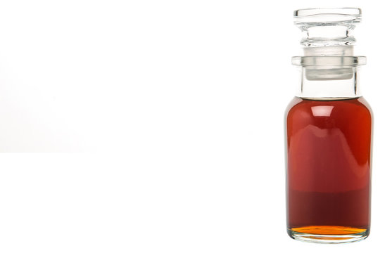 Maple vinegar in glass vial over white background