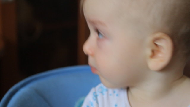 baby puts a pacifier in his mouth