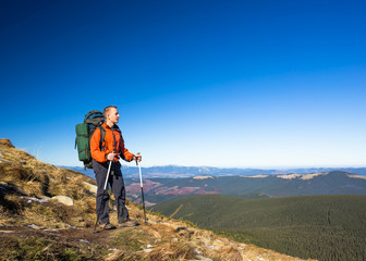 Fototapeta na wymiar Hiker with Backpack in the wilderness on mountains