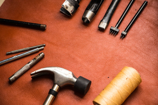 Leather crafting tools on work table.