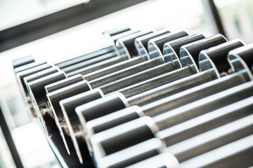 Rows of stainless dumbbell in the gym