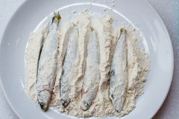 raw fish smelt in flour ready for frying